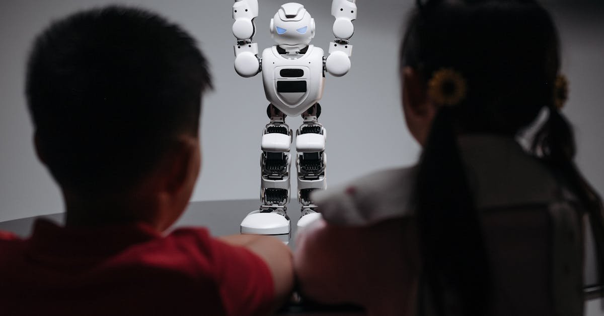 Two children observe a humanoid robot on a table, exploring technology and innovation.
